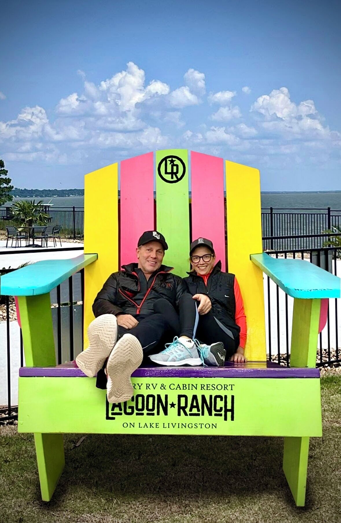 A colorful Adirondack chair with a logo and text indicating it is part of a RV & cabin resort on Lake Livingston.