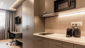 A modern kitchen with a built-in microwave, a coffee maker, and a toaster on the counter. - WYZ Museum by UPSTREET (Athens)