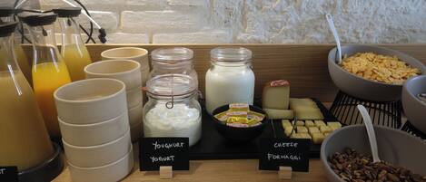 A breakfast buffet with various food items and beverages.