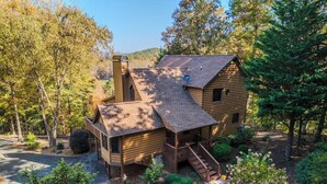 A log cabin with a porch, surrounded by trees and a driveway. - Cardinal and Bear Lodge (Blue Ridge)