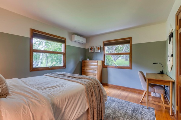 First-floor bedroom with a queen bed and mini split AC.