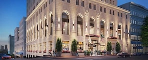 A large, historic building with multiple storefronts on the ground floor, likely a hotel or commercial complex. - CozySuites - Sky Central (Cincinnati)