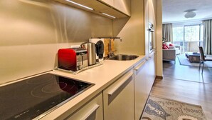 A modern kitchen with a built-in stove, a toaster, and a sink. - Lovely apartment for 2 guests with WIFI, TV and balcony (Seefeld In Tirol)