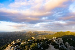 A mountainous landscape with rocky terrain and a dirt path. - La Suara Manna (Telti)