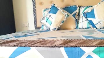 Desk, laptop workspace, bed sheets