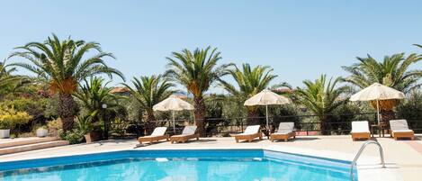 Seasonal outdoor pool, open 8:00 AM to 7:00 PM, pool umbrellas