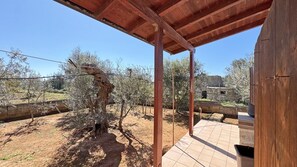 An outdoor patio area with a wooden pergola, a tiled floor, and olive trees. - Villa Ulivo Sleeps 7 Garden Close to the sea (Alliste)