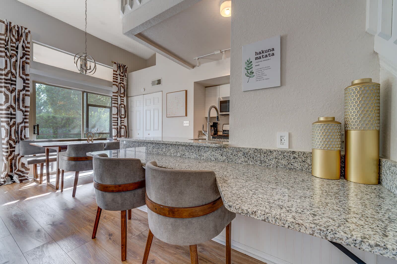 Modern kitchen bar with granite countertops and comfortable seating.