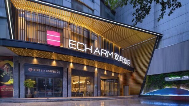 A modern building with a prominent 'ECHARM' sign, featuring a sleek design with horizontal lines and a reflective surface. - Echarm Hotel (Guangzhou Beijing Road Pedestrian Street Tianzi Pier) (Guangzhou)