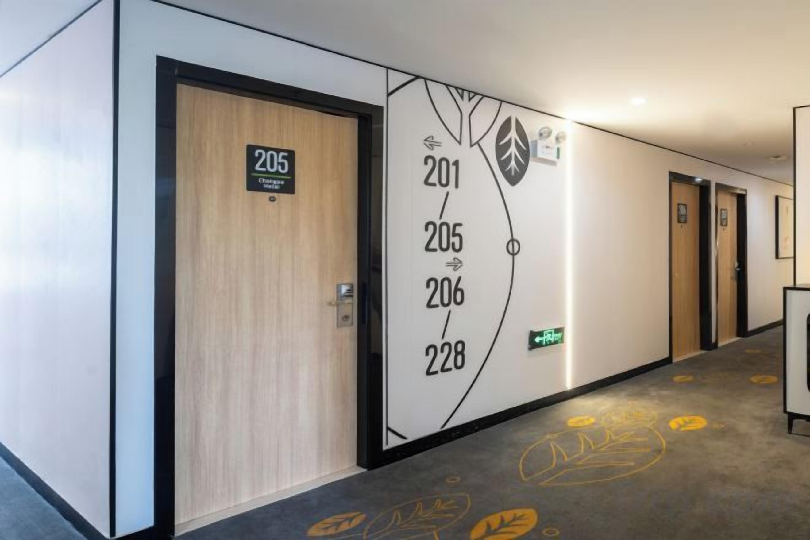 A hotel corridor with doors numbered 201, 205, 206, and 228.