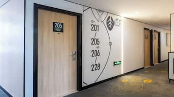 A hotel corridor with doors numbered 201, 205, 206, and 228.