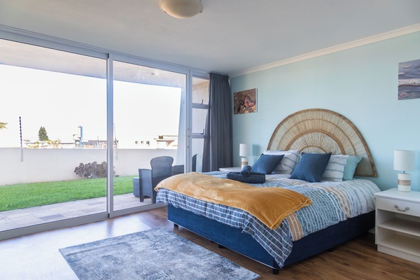 Main bedroom with king bed and sliding doors on to private patio