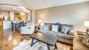 A modern living room with a sofa, armchairs, a coffee table, and a dining area with chairs and a table. - Swim, Game, Relax & More: Family Getaway in Frisco (Frisco)