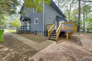 A two-story house with a wooden staircase and a porch. - 7 Mi to Dtwn Raleigh: Bbq-ready Townhome! (Raleigh)