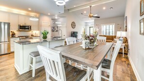 A spacious kitchen with a central island, white cabinetry, and modern appliances. - < 1 Mi to Golf & Marina: Inviting Home in Afton! (Afton)
