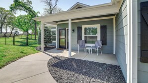 A covered patio with a table and chairs, a small tree, and a gravel area. - < 1 Mi to Golf & Marina: Inviting Home in Afton! (Afton)