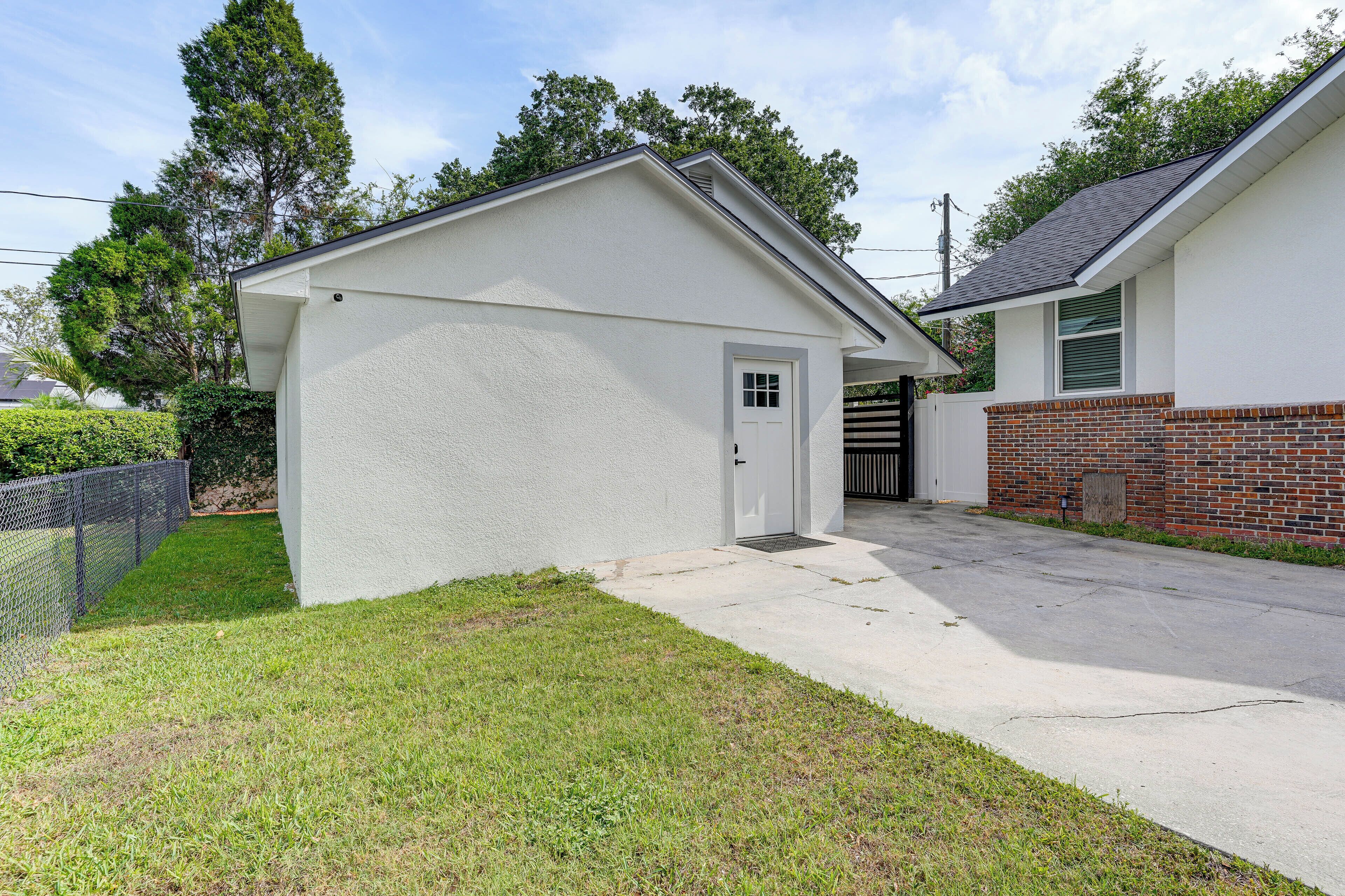 A two-story house with a garage, a brick exterior, and a well-maintained lawn.