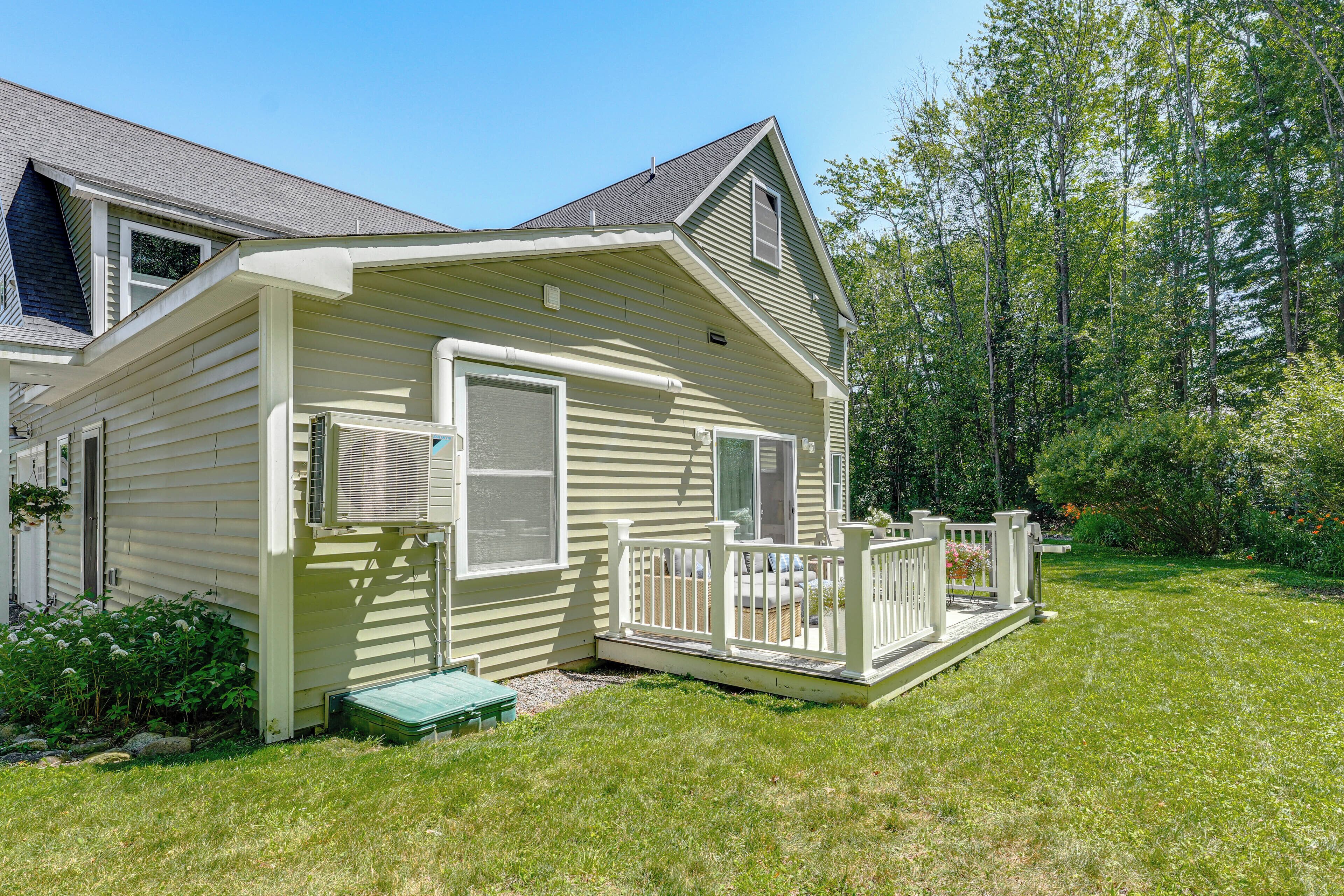 A single-story house with a front porch, a covered entryway, and a small deck.