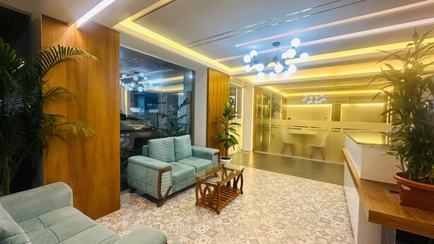 A modern lobby with a seating area, a reception desk, and a glass partition. - Royal Regent Suites Dhaka (Dhaka)