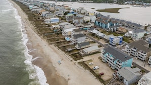 An aerial view of a coastal town with beachfront properties, a marina, and a beach. - Top Floor 2 Bdrm/2 Bath OCEAN FRONT,BEACH ACCESS condo.  Sleeps 6 with Linens! (Carolina Beach)
