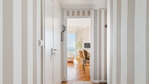 A hallway leading to a dining area with a view of the outdoors.