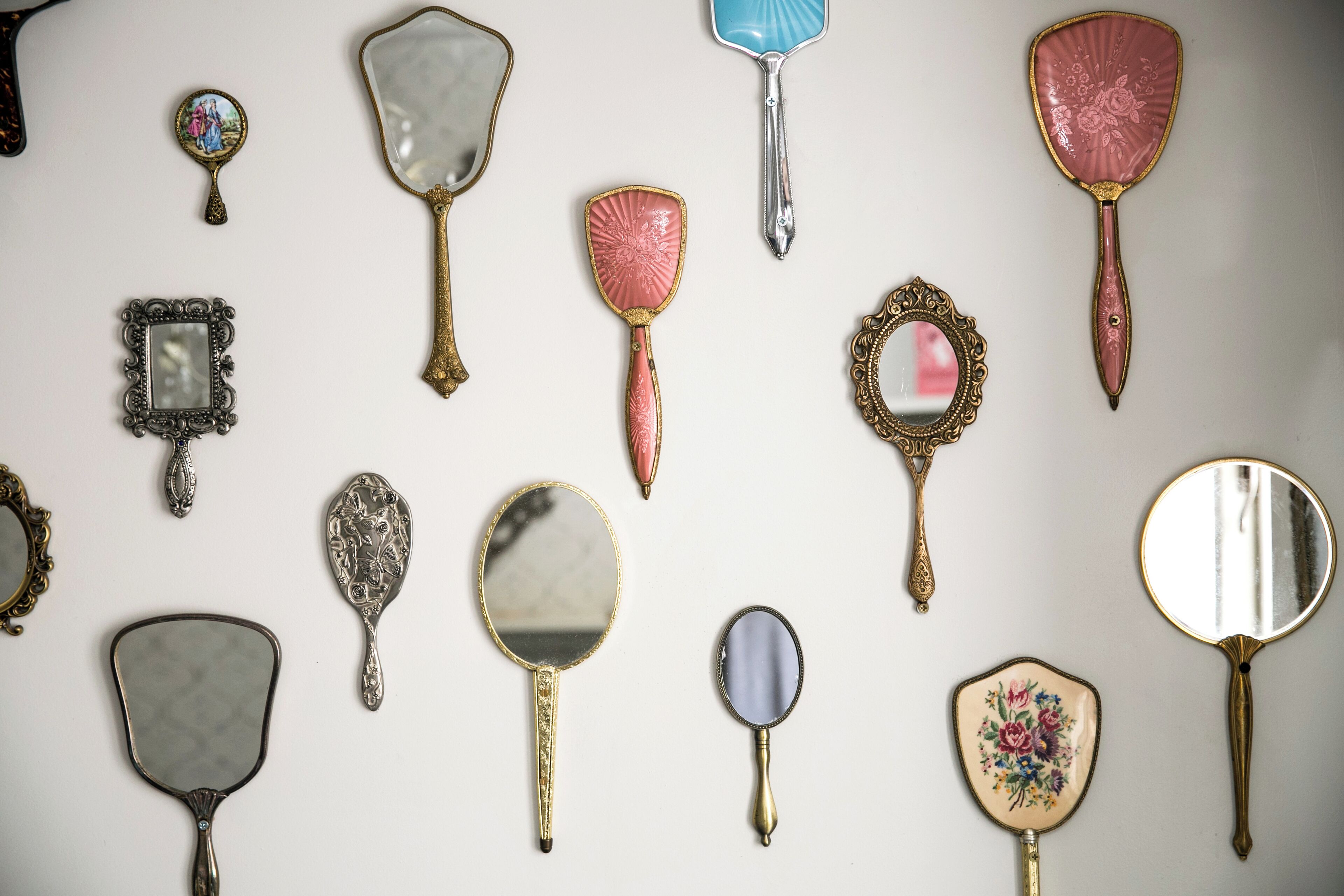 A collection of antique mirrors and picture frames on a white background.