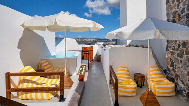 A rooftop terrace with white walls, stone accents, wooden furniture, and white umbrellas. - Orasis House – Santorini Retreat w/ Pool & Views (Akrotiri)