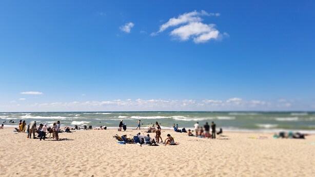 A beach with people sunbathing and swimming, and the ocean in the background. - Steps to McKinley Beach walk to all in Union Pier Fire Pit (Union Pier)
