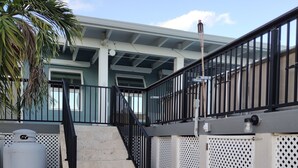 A staircase leading to a building with a metal railing and a white fence. - Charming 1-Bedroom Apartment on Beautiful St. Croix, USVI with Pool & Ocean View (Christiansted)