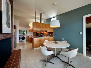 Enjoy cooking and dining in this stylish kitchen with a central island, oven, and sink.