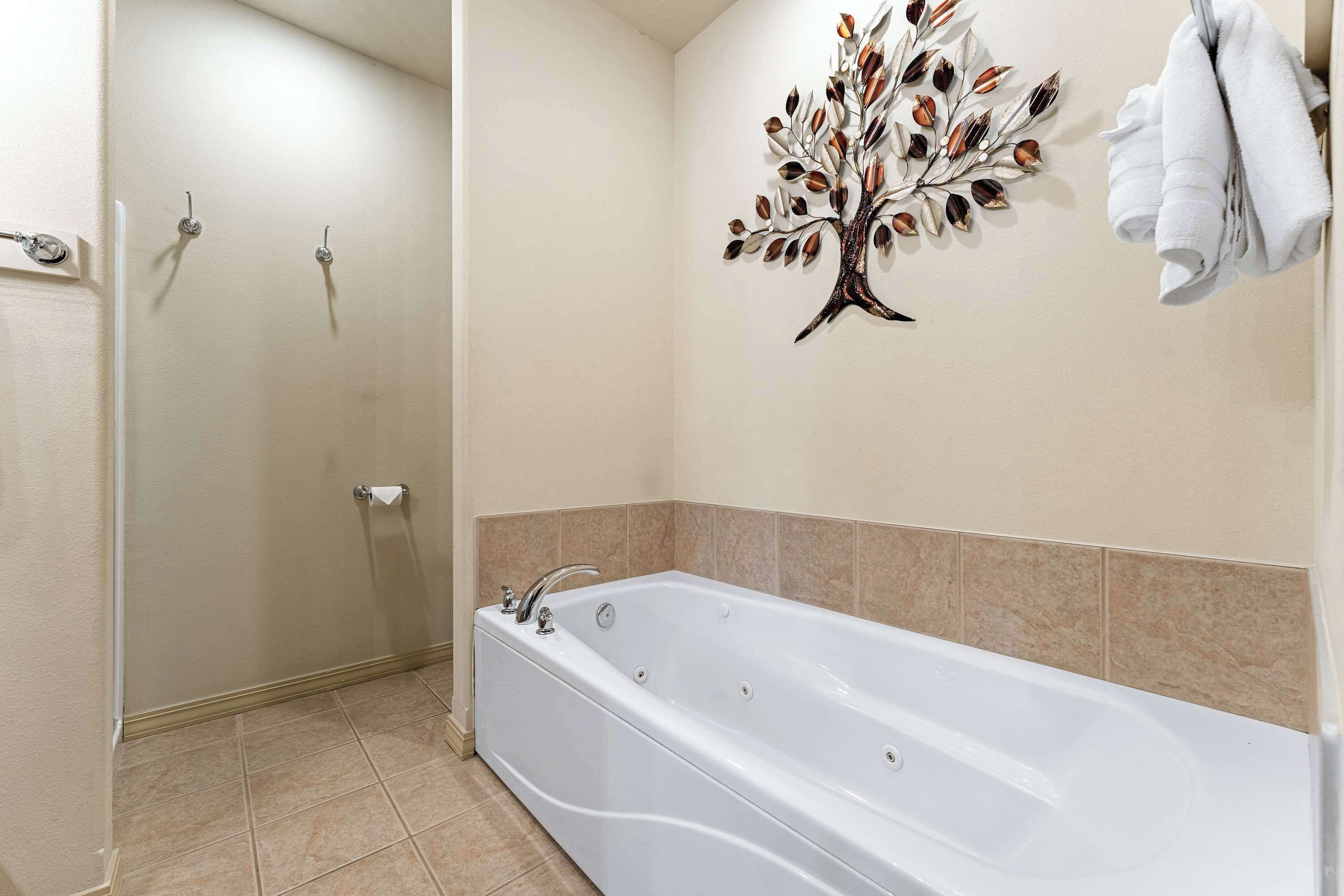 A large single vanity, shower, & soaking tub are available in the king ensuite