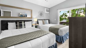 A bedroom with two beds, a ceiling fan, a window with a view, and a wooden headboard. - Dockside Dream w/ Kayak & Dock (Rocky Mount)