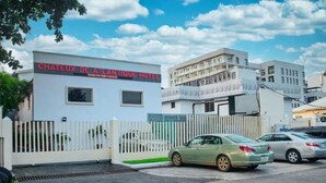 A hotel named "Chateux de l'Atlantique Hotel" with a white facade and a gated entrance.