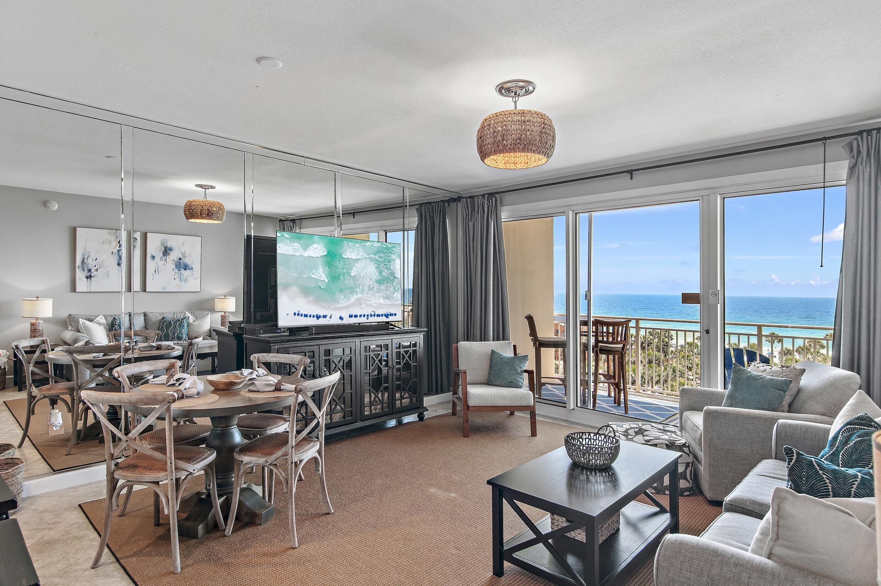 A spacious living area with a large TV, dining table, and comfortable seating.