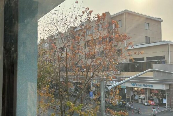 A multi-story building with a storefront labeled 'Fresh Fish.' - Shanghai Jinhaiwan Hotel (Haiwan University Town) (Shanghai)