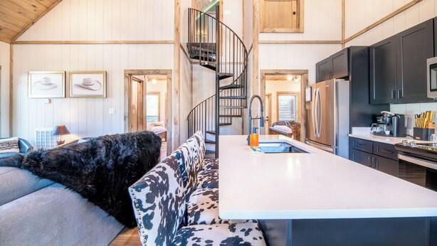 A spacious kitchen with a central island, a built-in stove, and modern appliances. - *Modern 3BD Cabin w/ Hot Tub + Arcade! Near TOWN!* (Pigeon Forge)