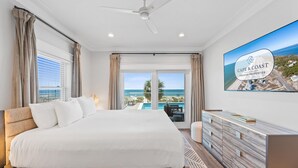 A hotel room with a bed, a TV, a view of the ocean, and a balcony. - Clementine: 7 Bedrooms, Beachfront in Mexico Beach, Private Pool, Game Room (Mexico Beach)