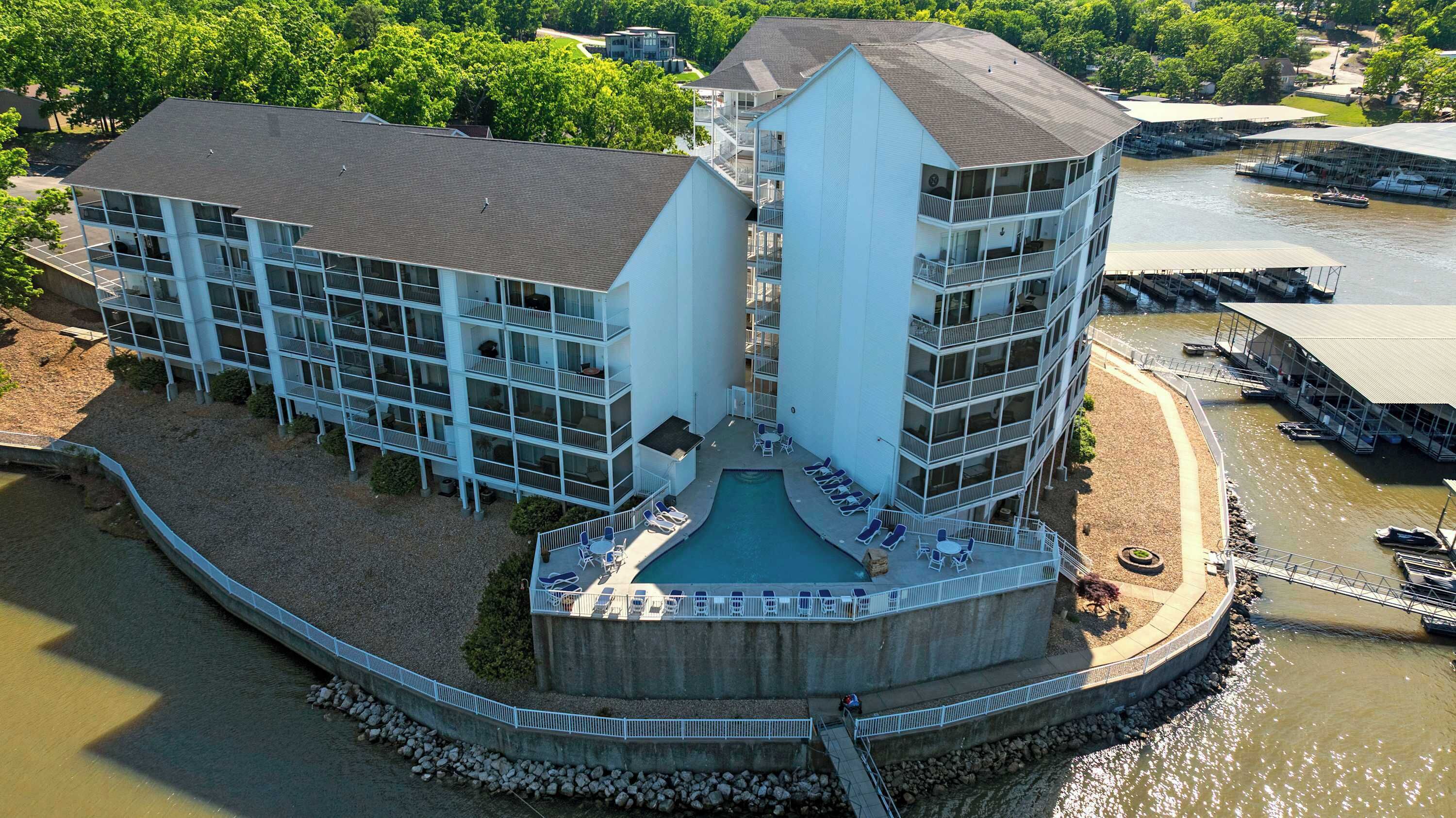 A multi-story hotel with a central courtyard, balconies, and a pool.