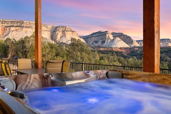 Banheira de hidromassagem com vista para uma paisagem montanhosa.