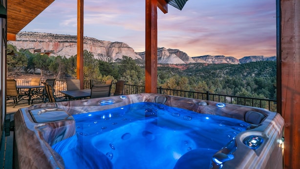 A hot tub with a panoramic mountain view.