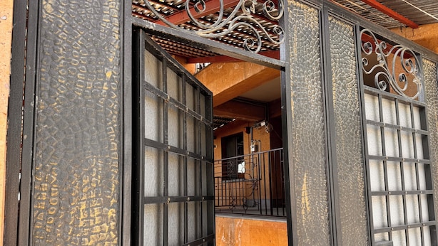 A traditional Japanese gate with intricate metalwork and a wooden interior. - Velvet Vouge Hostel (Yerevan)