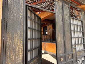 A traditional Japanese gate with intricate metalwork and a wooden interior.