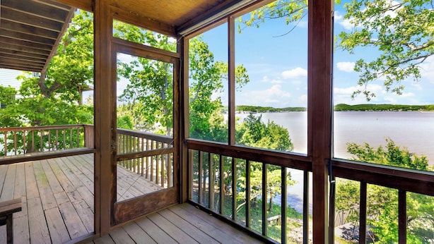 A wooden deck with a view of a lake and trees. - Sunset Escape - Fit For 8 (Gravois Mills)