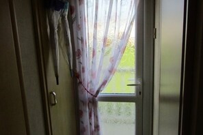 View through a door to a well-maintained lawn.