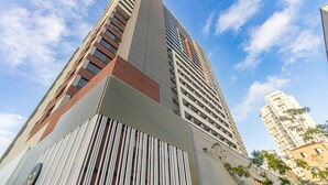 A high-rise building with a modern architectural design, featuring a prominent vertical element and a series of balconies. - Cozy Near Allianz Parque Sp-p1609a (São Paulo)