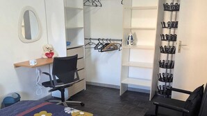 A bedroom with a bed, a desk, a chair, a wardrobe, and a shoe rack. - Apartamento a 5 minutos de Luxemburgo fully equipped kitchen, lovely terrace (Audun-le-Tiche)