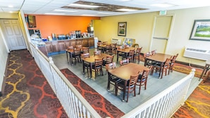 A hotel lobby with a central seating area, a reception desk, and a buffet. - Montrose Valley Lodge (Montrose)