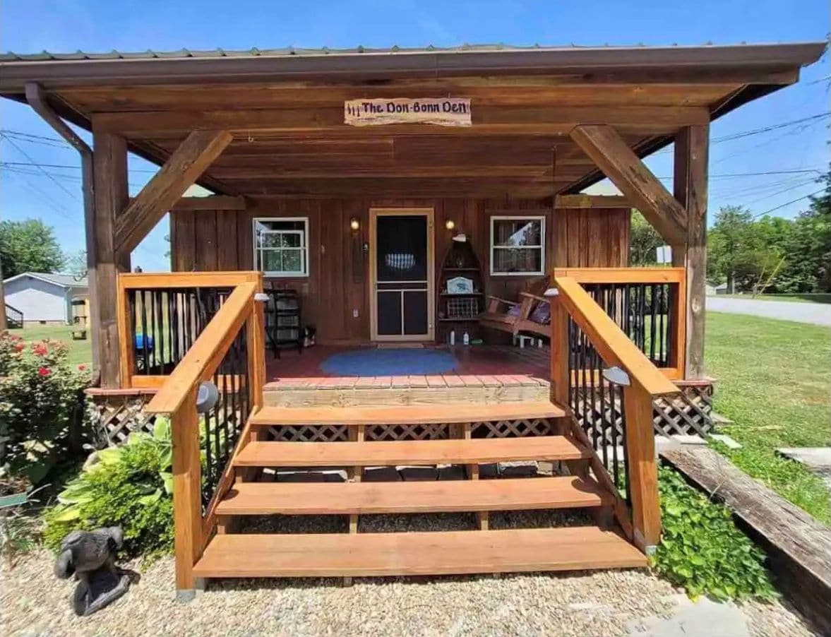 A wooden building with a porch, a sign reading "The Don-Bonn Inn," and a staircase leading to the entrance.