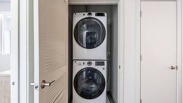 A laundry room with two stacked front-loading washing machines.
