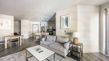 Apartment, 1 Bedroom | Living area | 50-inch TV with digital channels